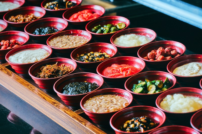 Assorted side dishes served in small bowls