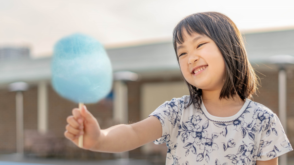a girl getting ready to eat cotton candy